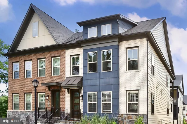a front view of a residential apartment building with a yard