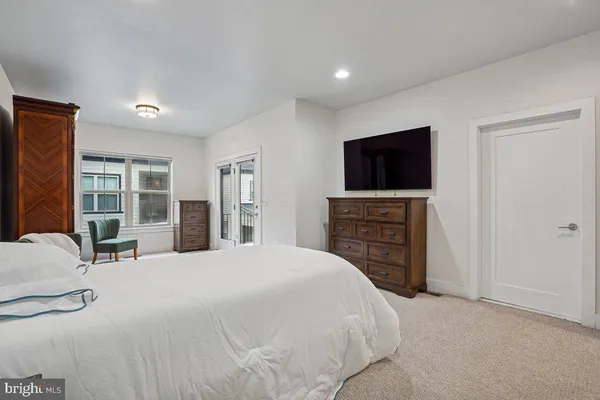 a view of a hallway with a couch and a mirror