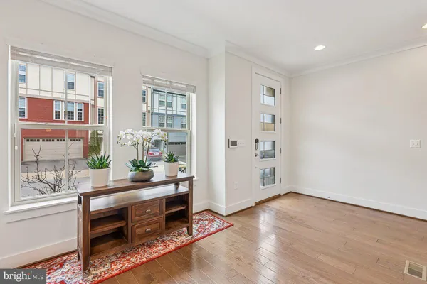 a room with a wooden floor and a window