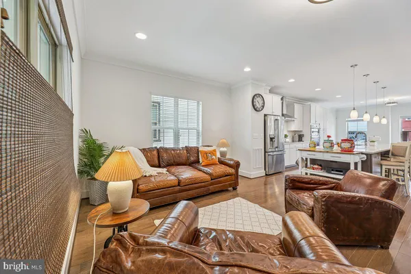 a living room with furniture and large windows