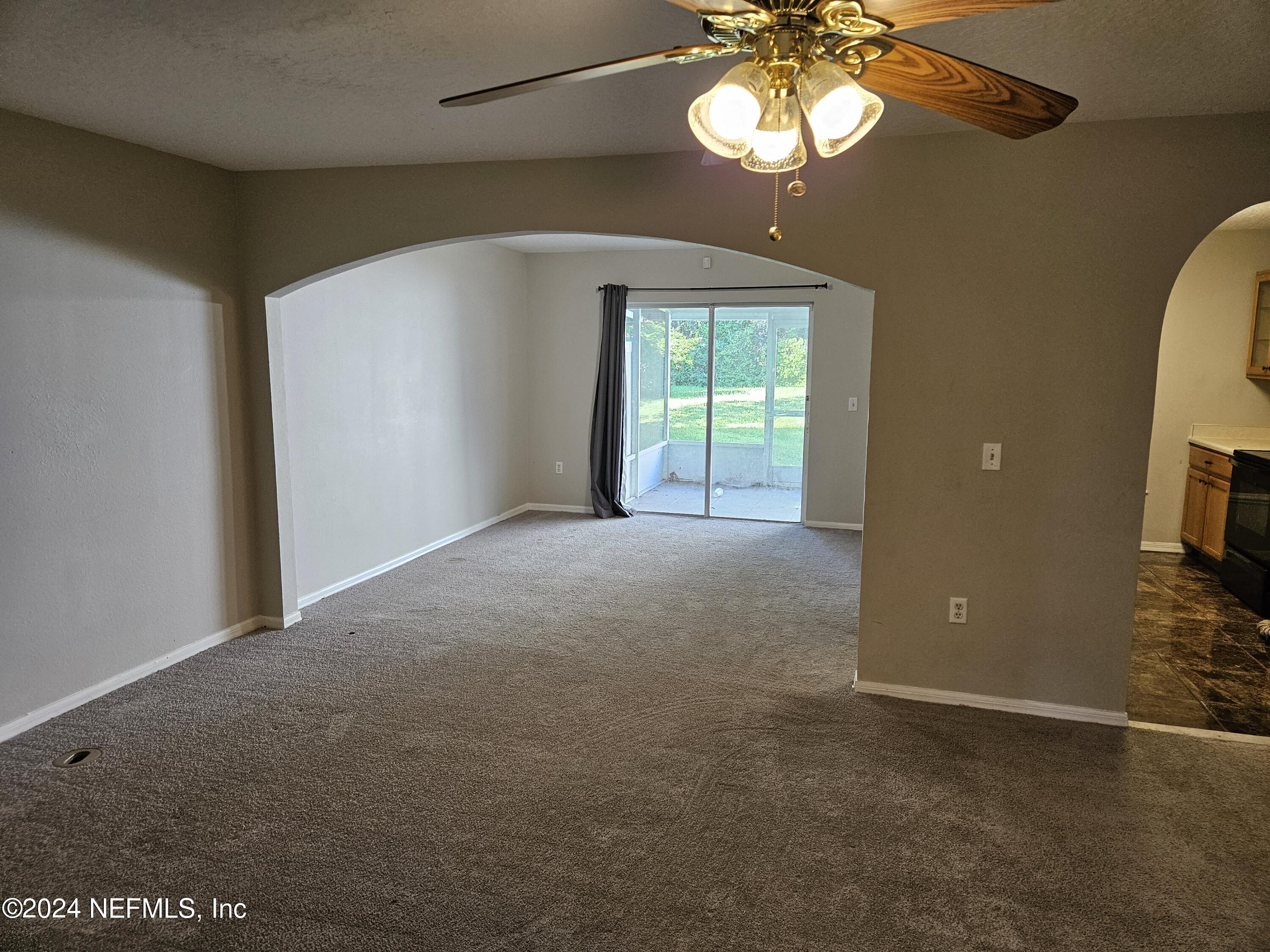 711 Talking Tree Drive Jacksonville, FL 32205 - Photo 14 of 61 a view of a livingroom with a chandelier fan and a window