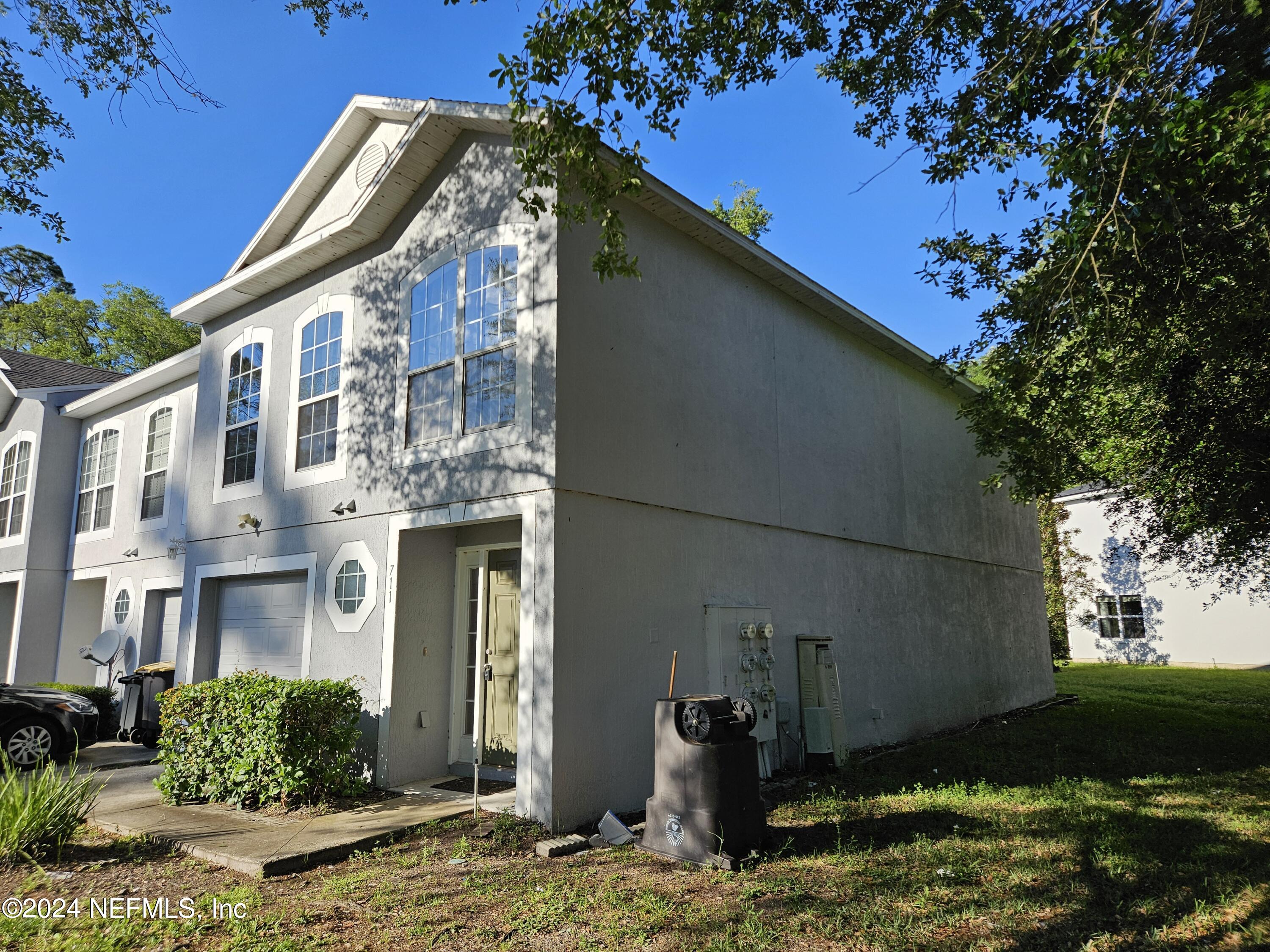 711 Talking Tree Drive Jacksonville, FL 32205 - Photo 2 of 61 a front view of a house with garden