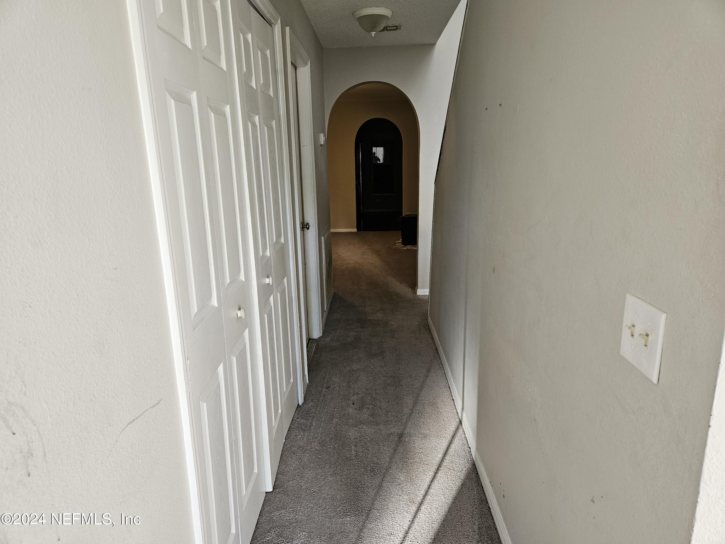711 Talking Tree Drive Jacksonville, FL 32205 - Photo 23 of 61 a view of a hallway with wooden floor and cabinet