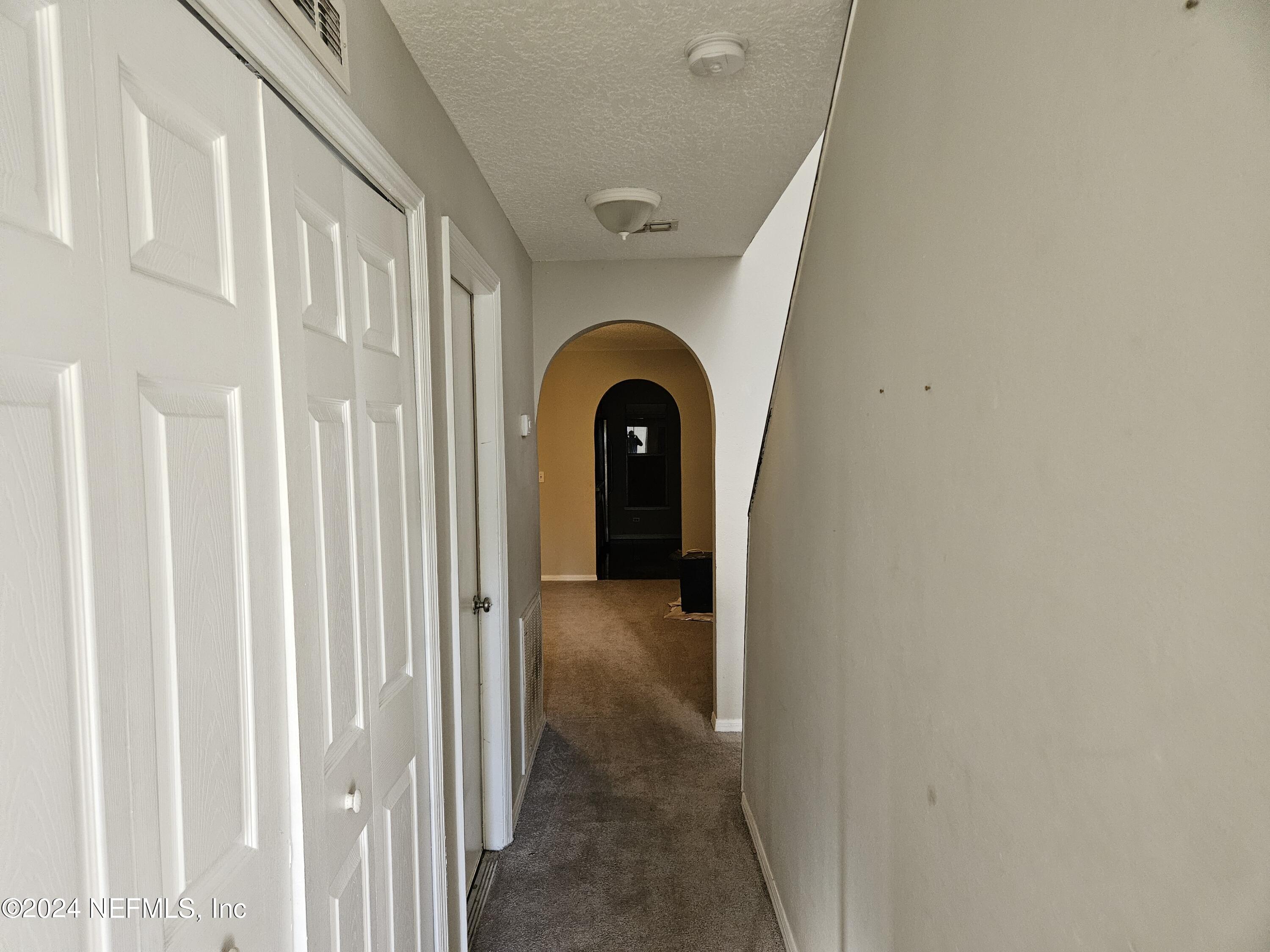 711 Talking Tree Drive Jacksonville, FL 32205 - Photo 24 of 61 a view of a livingroom with wooden floor a ceiling fan