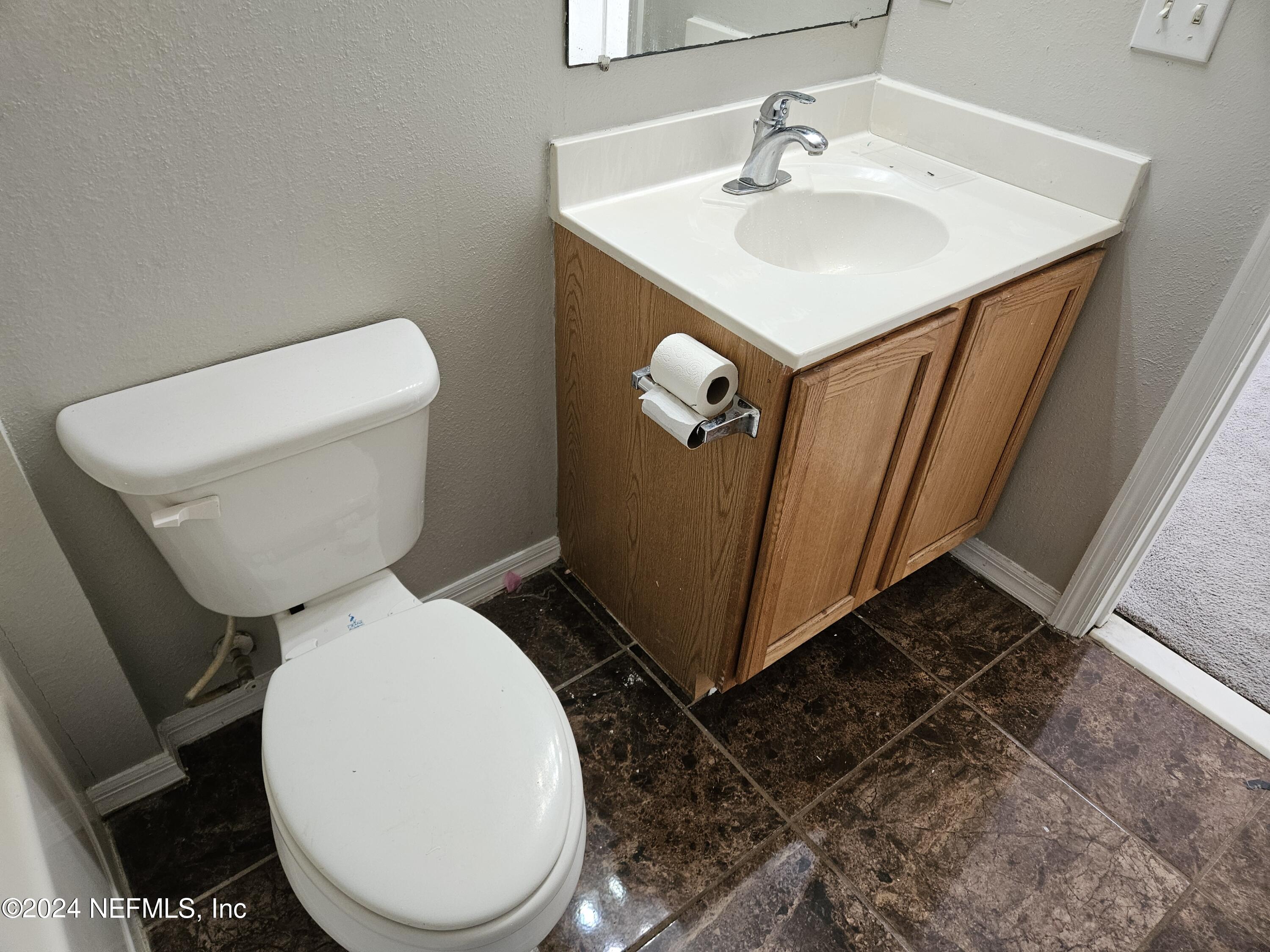 711 Talking Tree Drive Jacksonville, FL 32205 - Photo 36 of 61 a white toilet sitting next to a bathroom sink