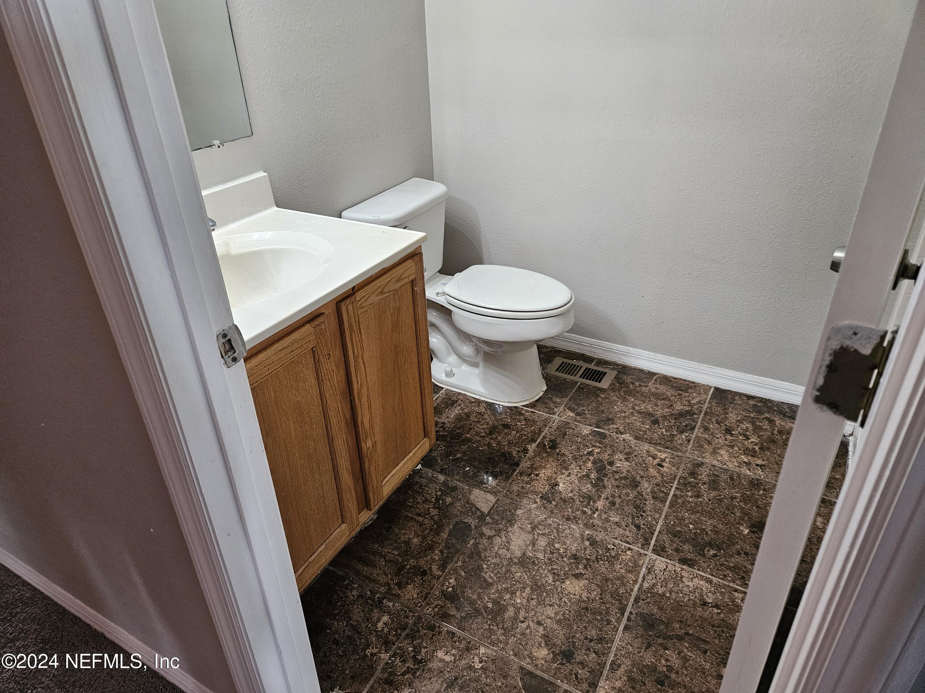 711 Talking Tree Drive Jacksonville, FL 32205 - Photo 43 of 61 a bathroom with a toilet and a sink