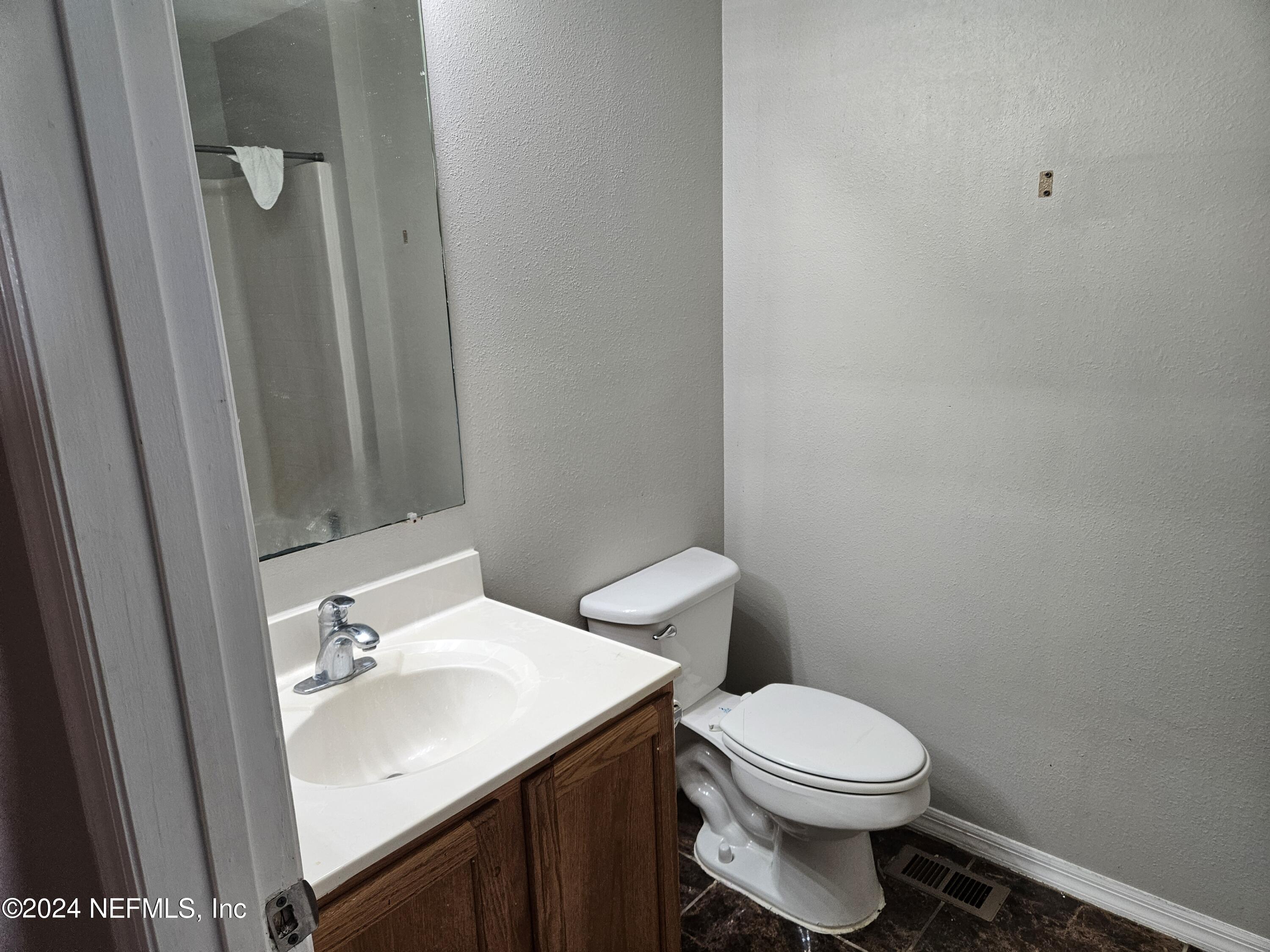 711 Talking Tree Drive Jacksonville, FL 32205 - Photo 44 of 61 a bathroom with a sink a toilet and a mirror