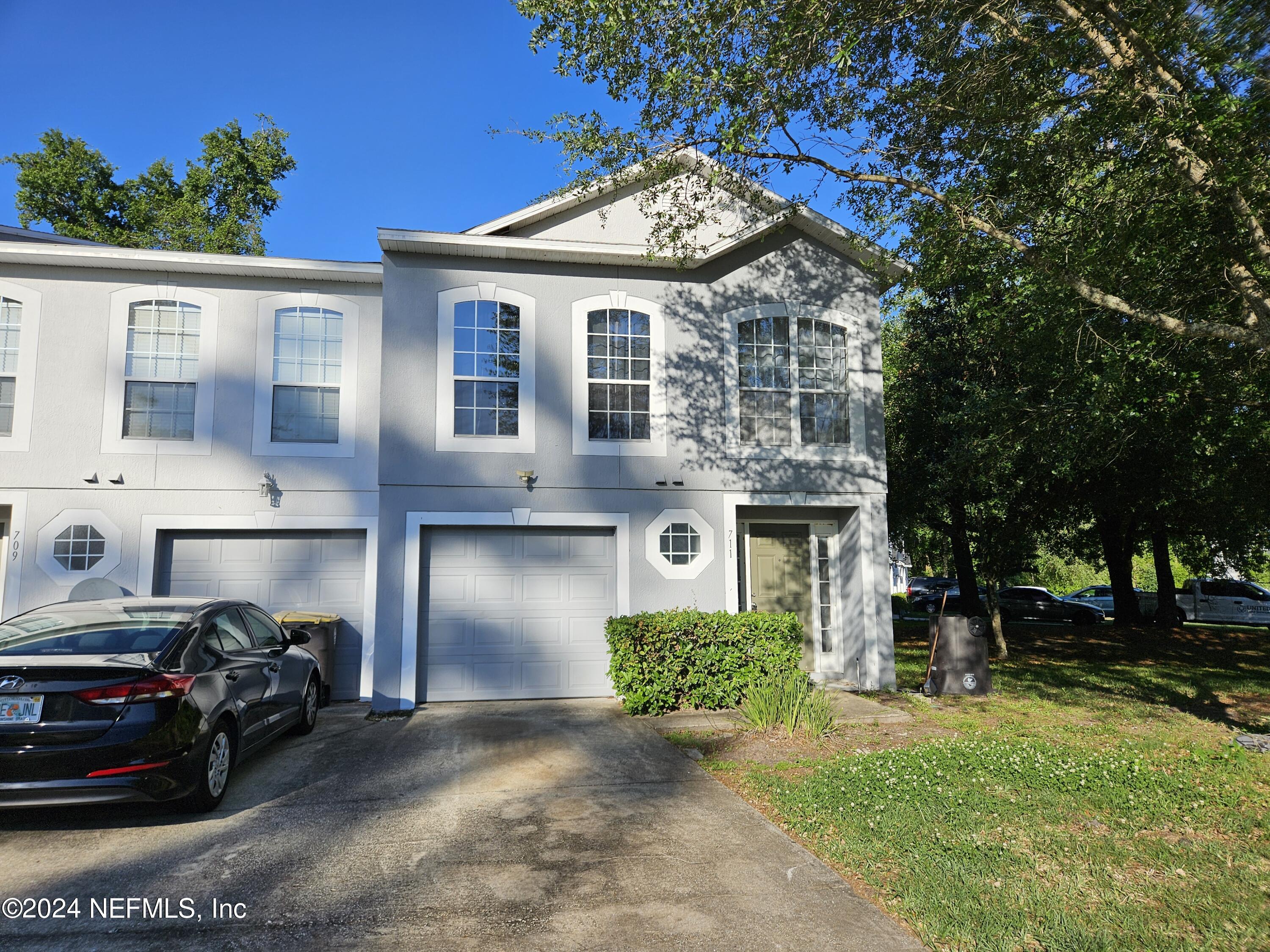 711 Talking Tree Drive Jacksonville, FL 32205 - Photo 61 of 61 a front view of a house with a garden and plants