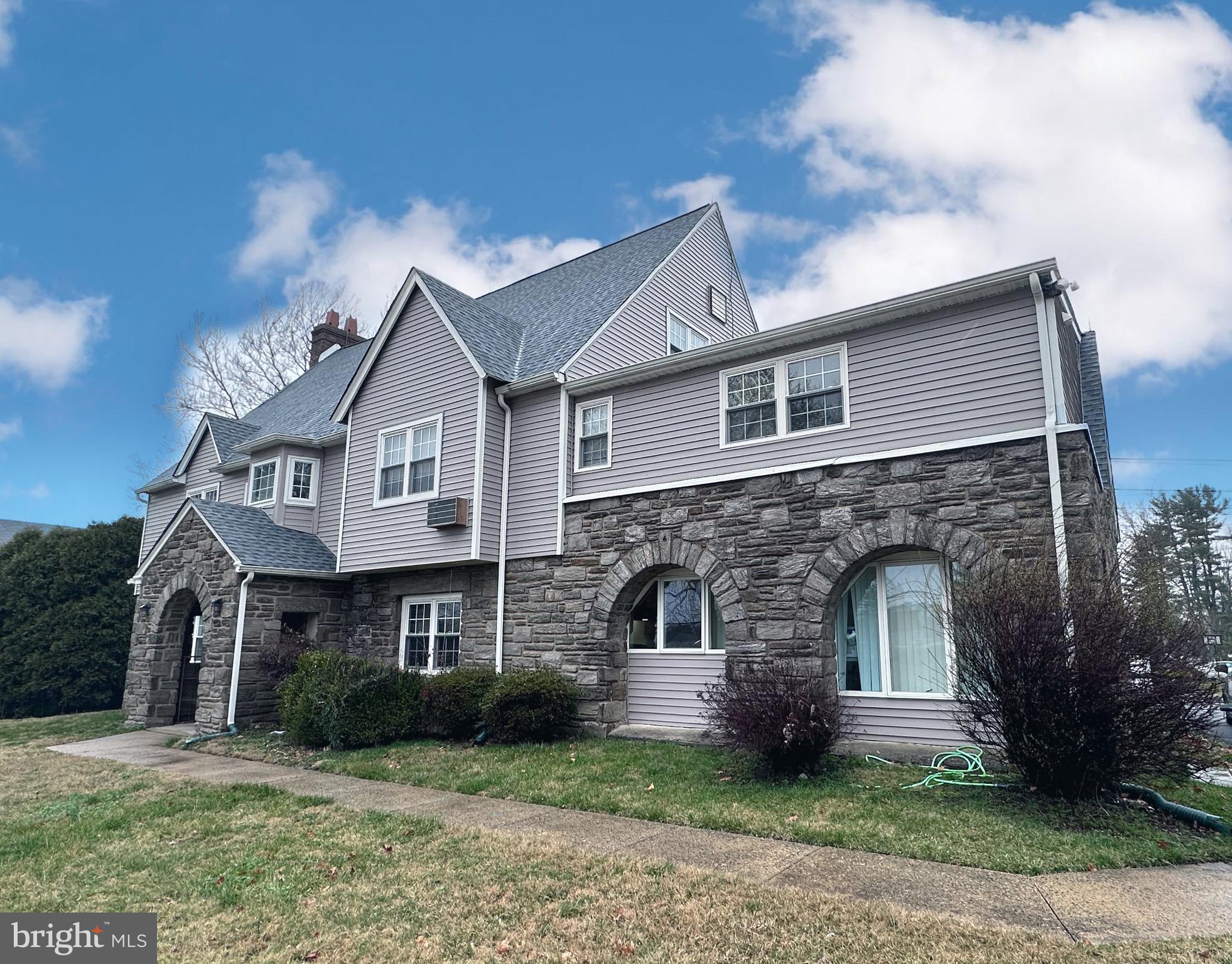 2250 Boyd Road, Unit A Huntingdon Valley, PA 19006 - Photo 1 of 18 a front view of a house with a garden