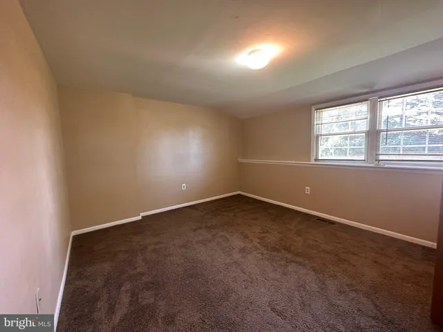 an empty room with a empty space and windows