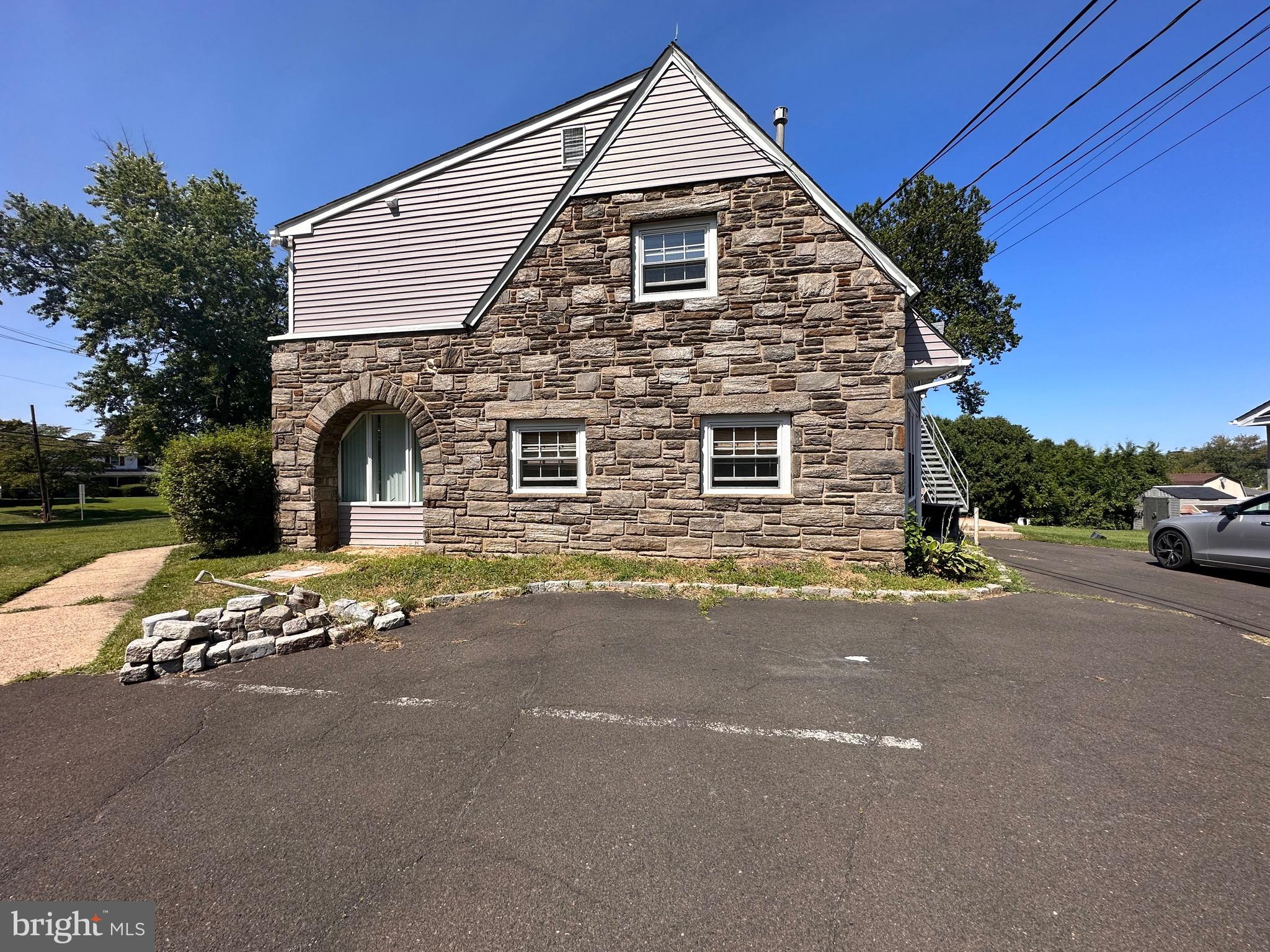 2250 Boyd Road, Unit A Huntingdon Valley, PA 19006 - Photo 3 of 18 a front view of a house with a garden