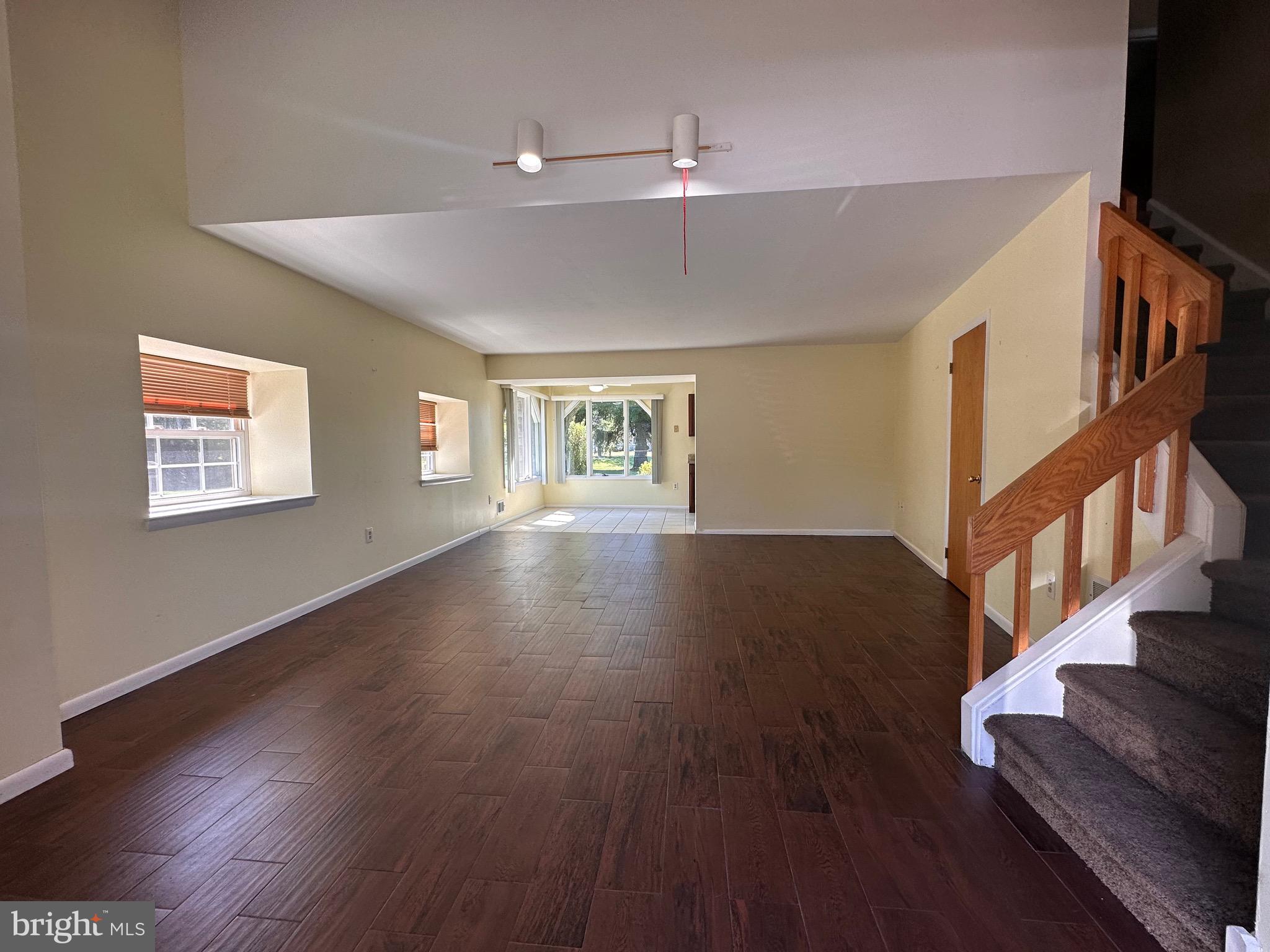 2250 Boyd Road, Unit A Huntingdon Valley, PA 19006 - Photo 6 of 18 a view of an empty room with wooden floor and a flat screen tv