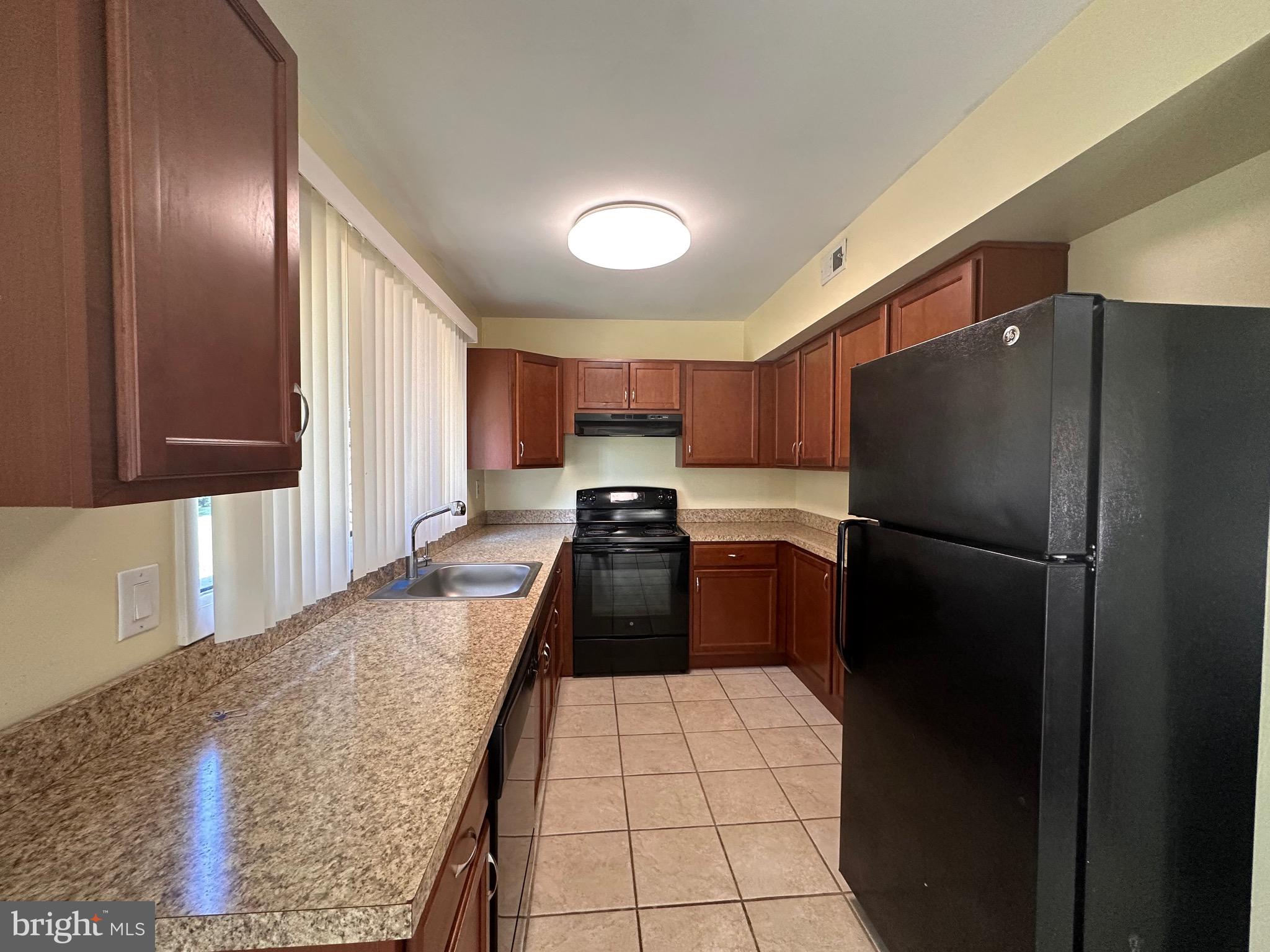 2250 Boyd Road, Unit A Huntingdon Valley, PA 19006 - Photo 9 of 18 a kitchen with a refrigerator and a sink