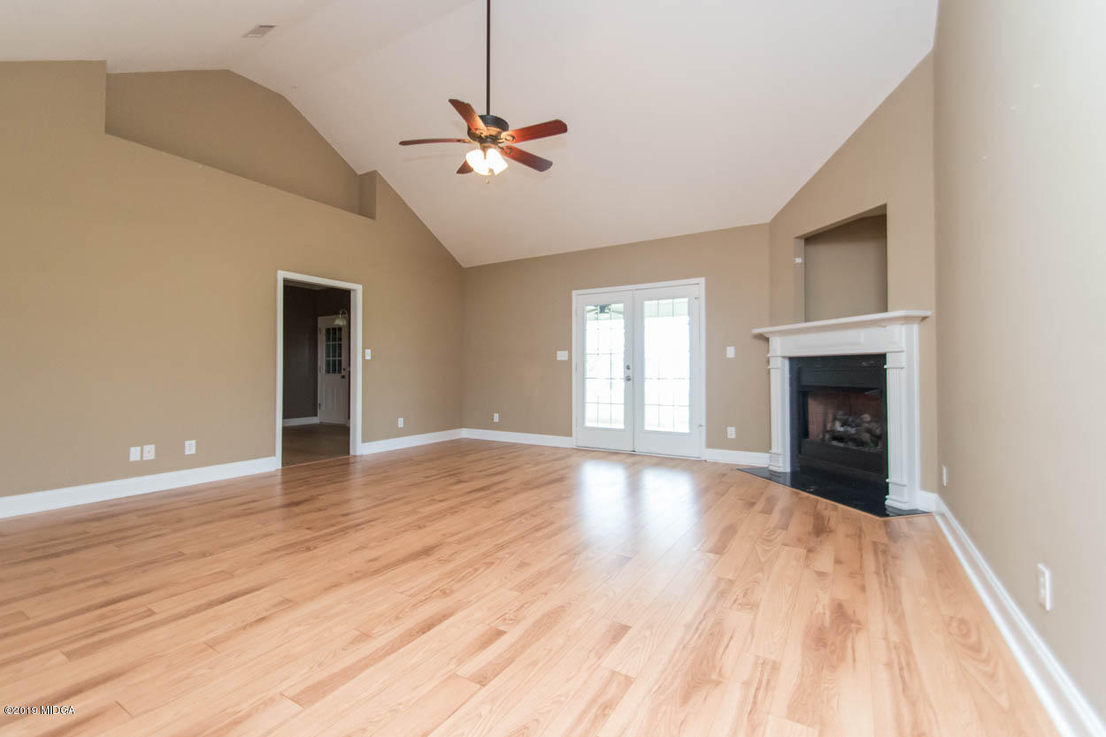 2725 Moseley Road Byron, GA 31008 - Photo 11 of 34 a view of an empty room with wooden floor and a window