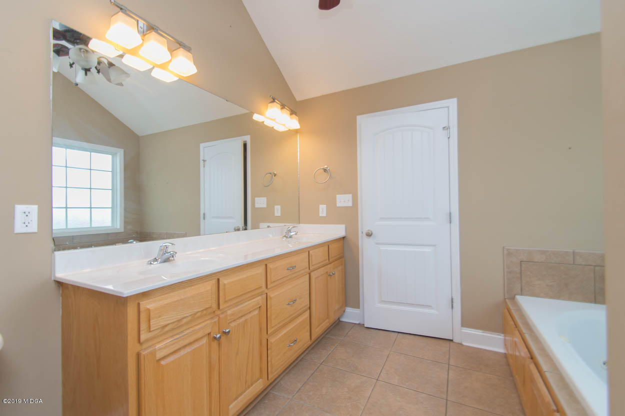 2725 Moseley Road Byron, GA 31008 - Photo 15 of 34 a bathroom with a sink a vanity and a mirror
