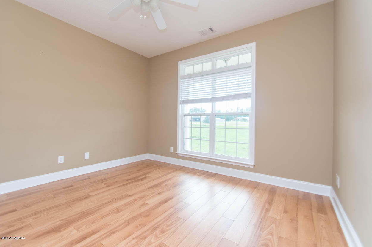 2725 Moseley Road Byron, GA 31008 - Photo 17 of 34 an empty room with wooden floor and windows