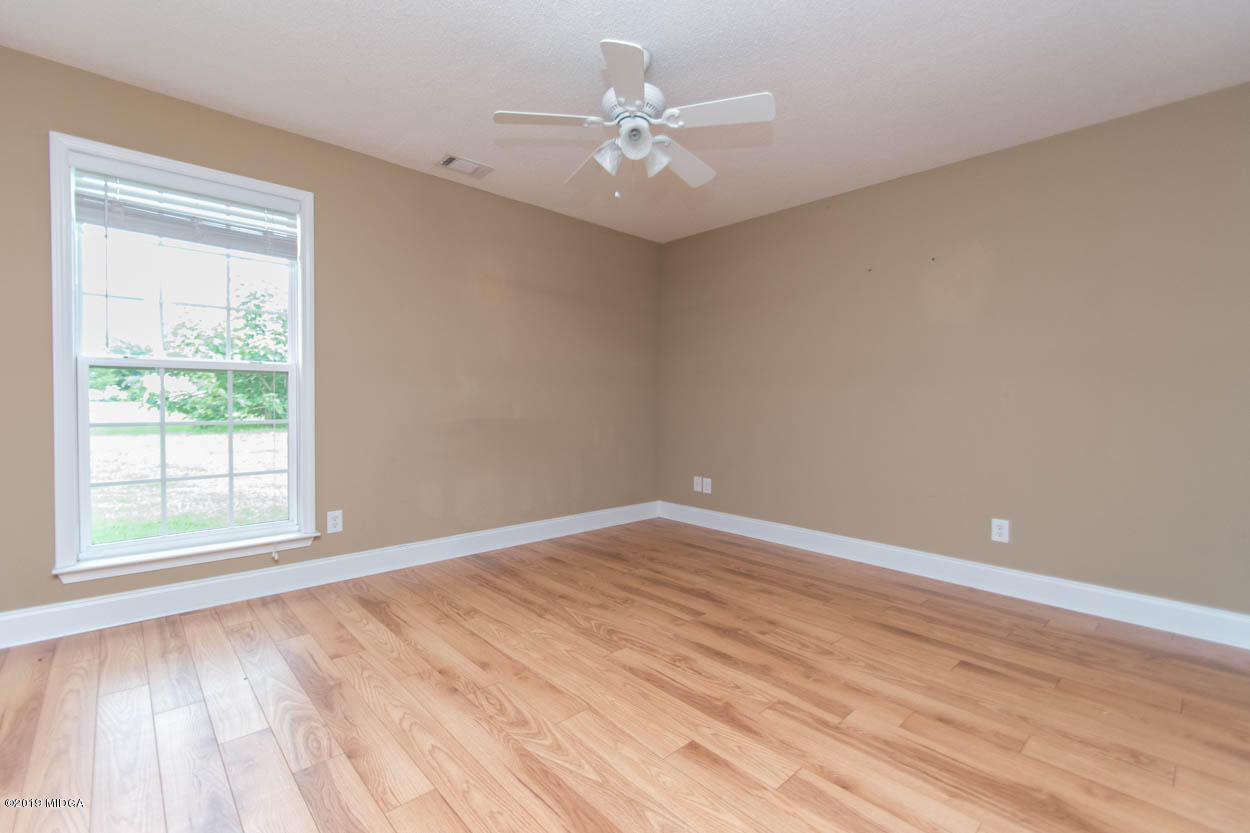 2725 Moseley Road Byron, GA 31008 - Photo 19 of 34 wooden floor in an empty room with a window