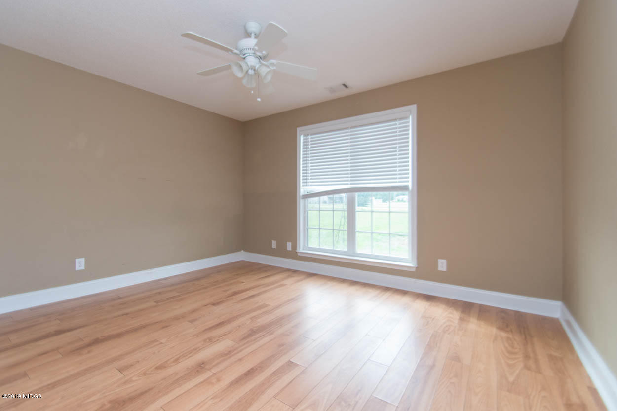 2725 Moseley Road Byron, GA 31008 - Photo 21 of 34 a view of an empty room with wooden floor and a window