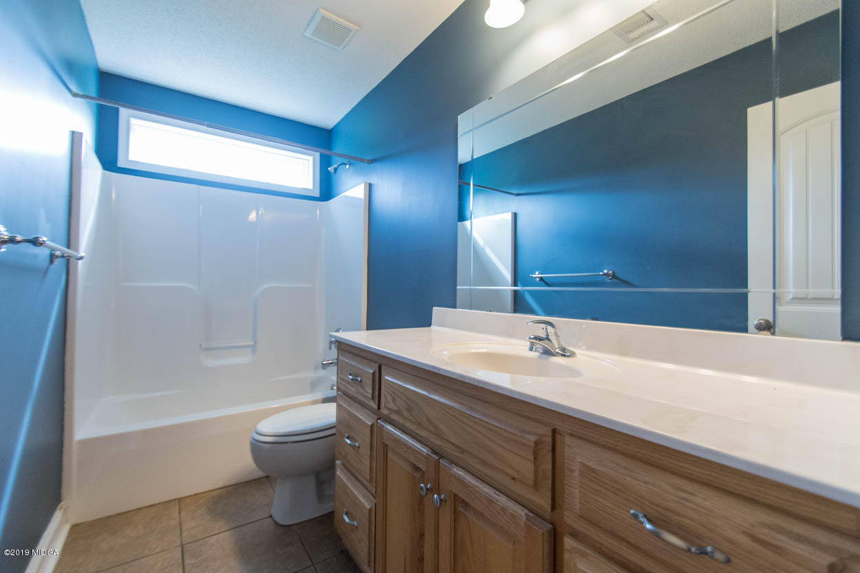 2725 Moseley Road Byron, GA 31008 - Photo 24 of 34 a bathroom with a sink a toilet and shower
