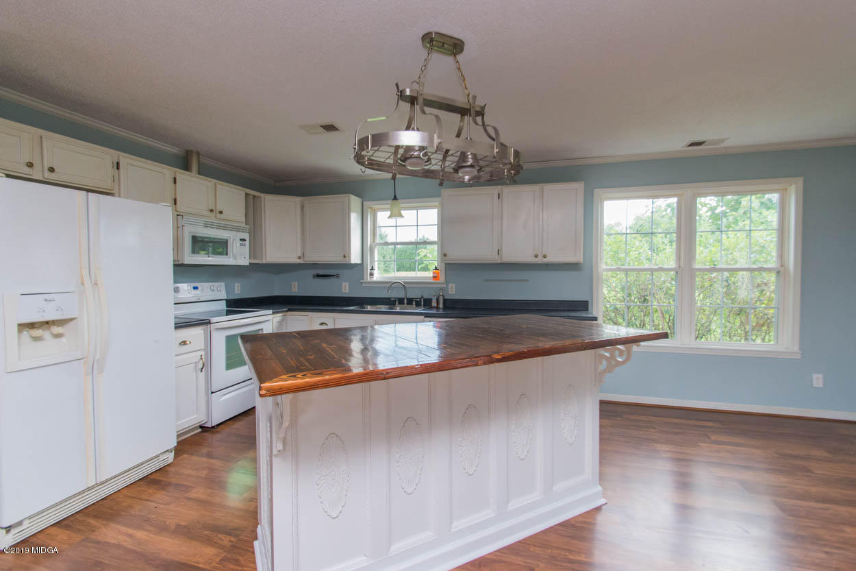 2725 Moseley Road Byron, GA 31008 - Photo 29 of 34 a large kitchen with stainless steel appliances granite countertop a stove a sink dishwasher and a refrigerator