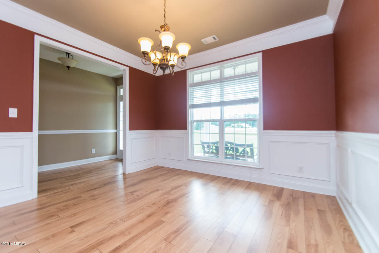 2725 Moseley Road Byron, GA 31008 - Photo 4 of 34 a view of an empty room with wooden floor and a window