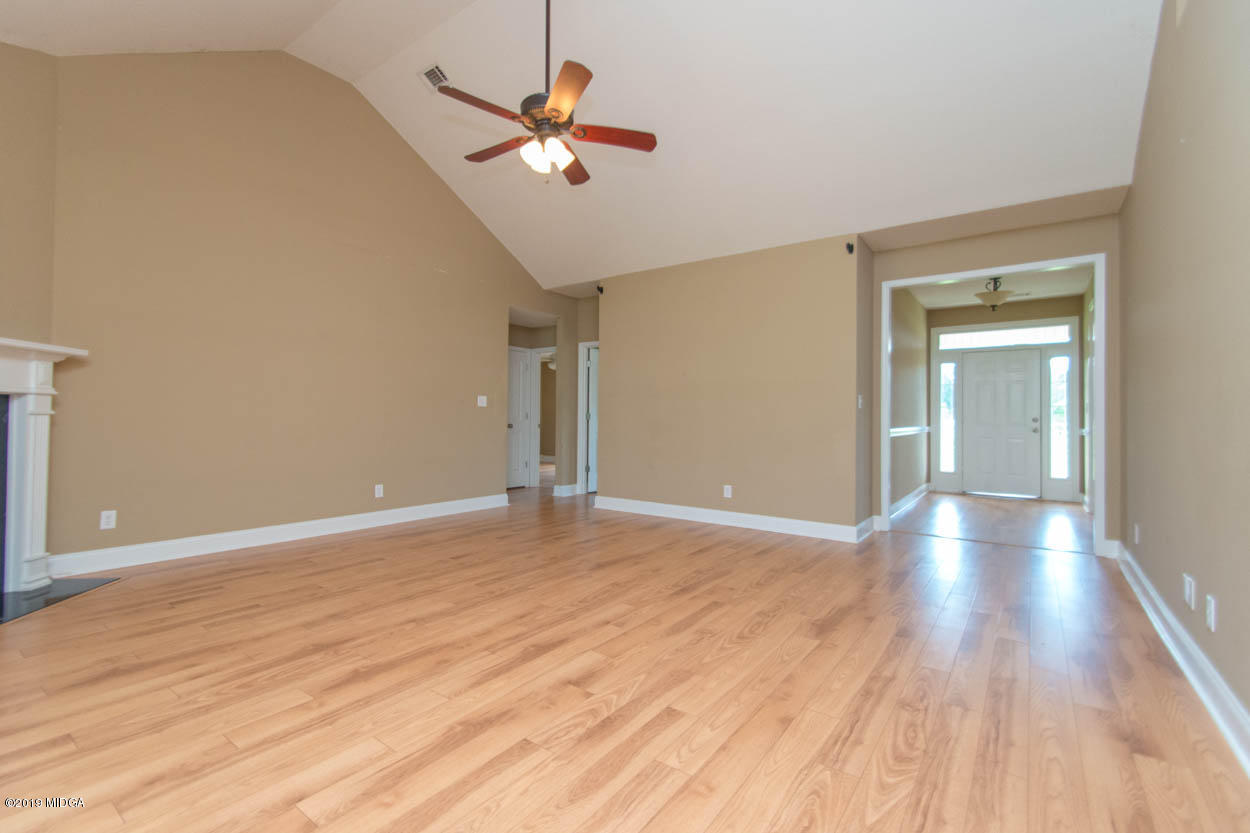 2725 Moseley Road Byron, GA 31008 - Photo 9 of 34 wooden floor in an empty room with a window