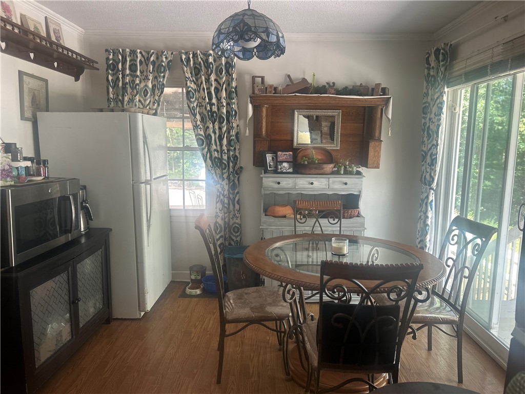 418 Saluda Road Williamston, SC 29697 - Photo 23 of 40 A cozy dining space features rich wood flooring and a sliding glass door for abundant natural light.