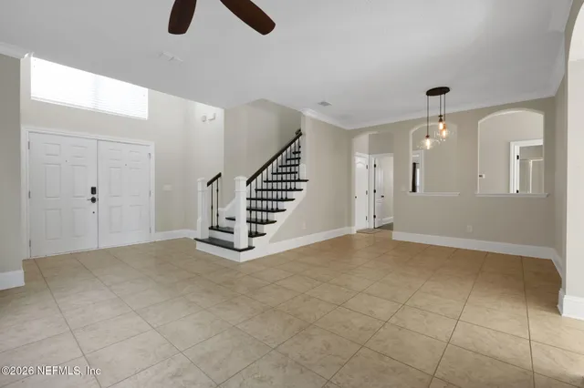 a view of a living room a ceiling fan and a rug
