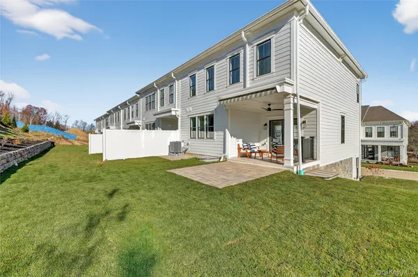 a view of an house with backyard and sitting area