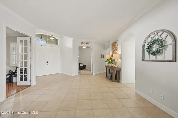 a view of an empty room with workspace and a window