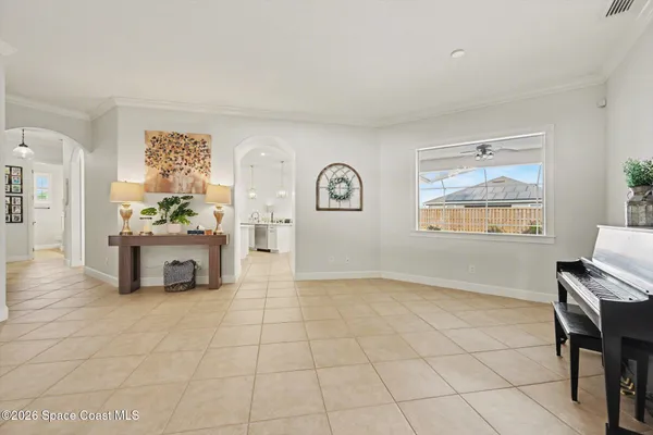 a view of a livingroom with furniture a dinning area windows and cabinet