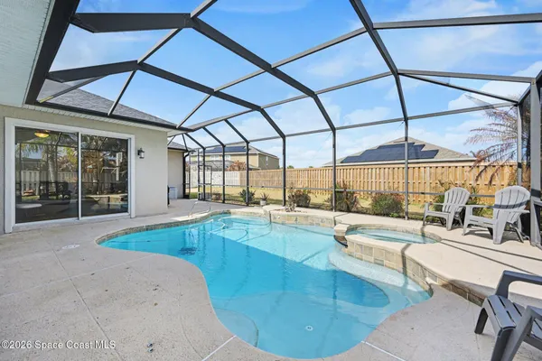 a large swimming pool with outdoor seating