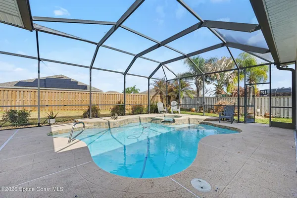 a view of a swimming pool with a lounge chair