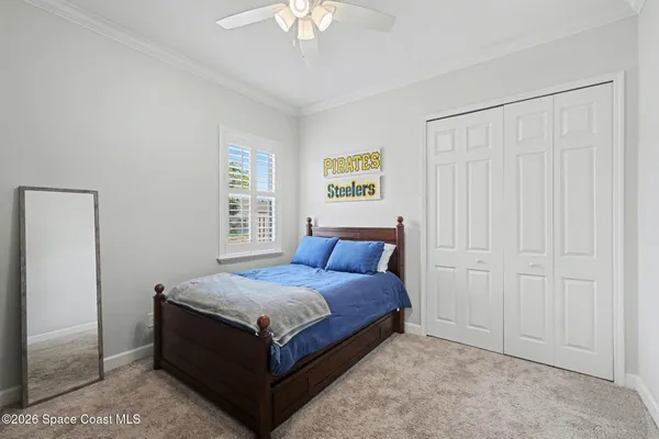 a bed room with a bed and a chandelier