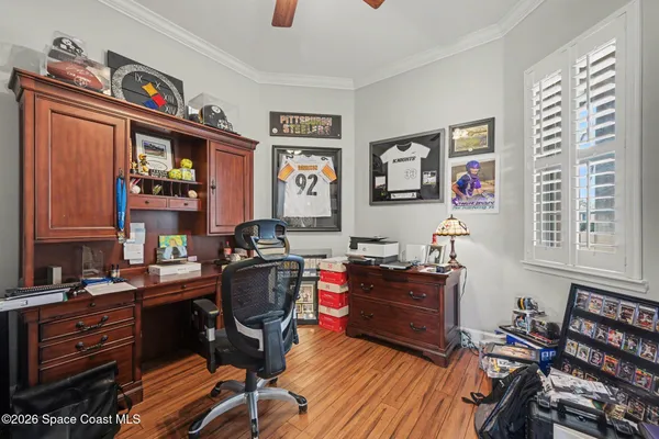 a view of a workspace with furniture and a window