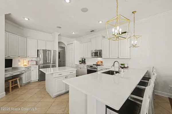 a kitchen that has a lot of cabinets in it and appliances