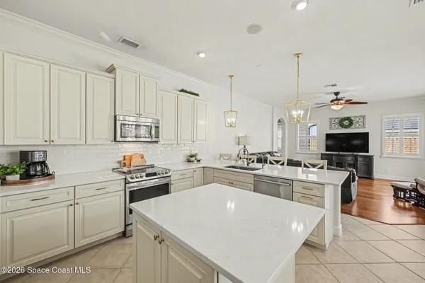 a kitchen with appliances a sink and cabinets