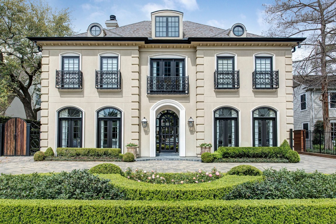 a front view of a house with a garden