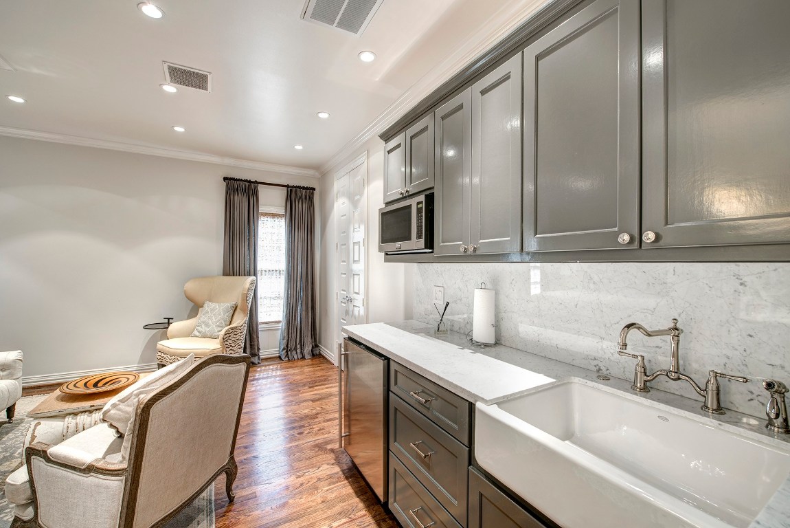 3440 Locke Lane Houston, TX 77027 - Photo 9 of 21 a hall with kitchen island stainless steel appliances a sink and a couch