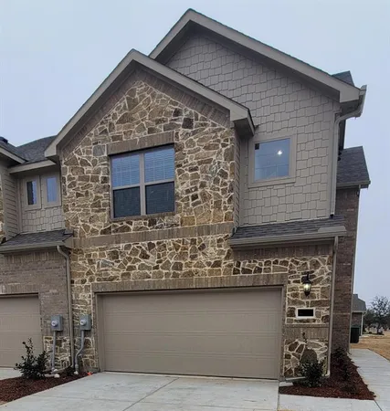 a front view of a house with garage