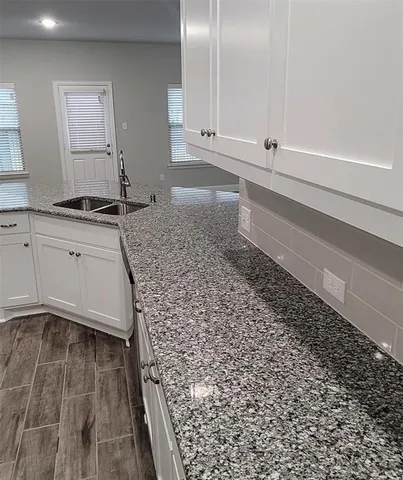 a kitchen with a sink and cabinets