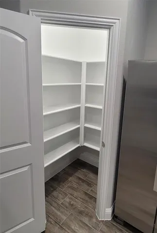 a view of walk in closet with empty racks
