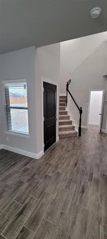 a view of an entryway with wooden floor