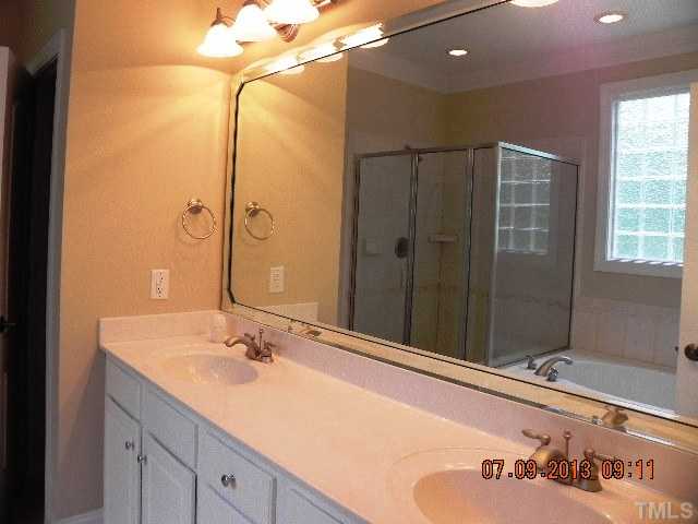 213 Waterville Street Raleigh, NC 27603 - Photo 14 of 24 a bathroom with a double vanity sink and mirror