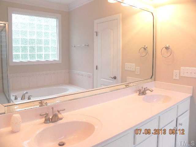 213 Waterville Street Raleigh, NC 27603 - Photo 15 of 24 a bathroom with a tub sink and mirror