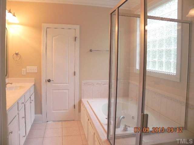 213 Waterville Street Raleigh, NC 27603 - Photo 16 of 24 a bathroom with a shower and a tub