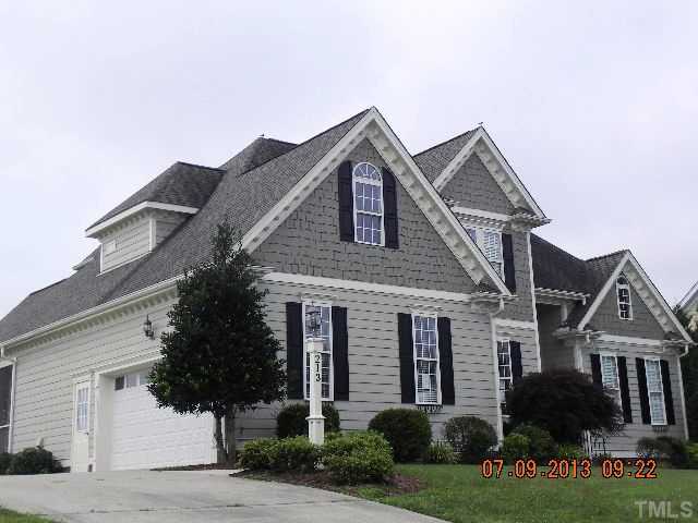 213 Waterville Street Raleigh, NC 27603 - Photo 2 of 24 a front view of a house with a yard and garage