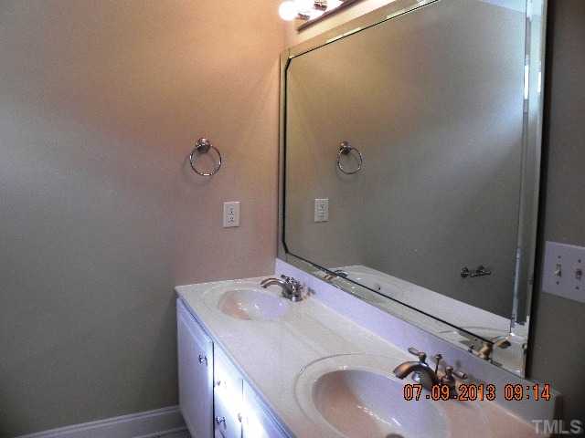 213 Waterville Street Raleigh, NC 27603 - Photo 21 of 24 a bathroom with a sink and a mirror