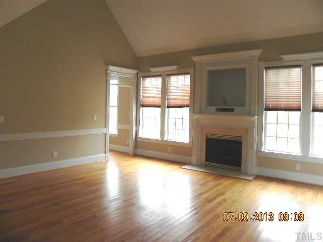 213 Waterville Street Raleigh, NC 27603 - Photo 6 of 24 a view of an empty room with wooden floor and a window