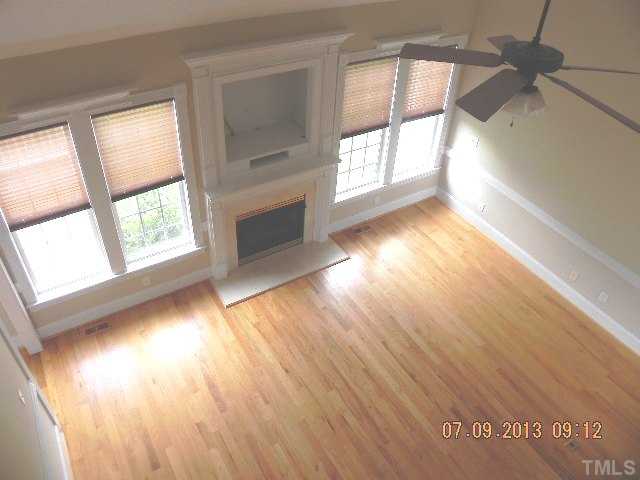 213 Waterville Street Raleigh, NC 27603 - Photo 8 of 24 a view of an empty room with wooden floor and a window
